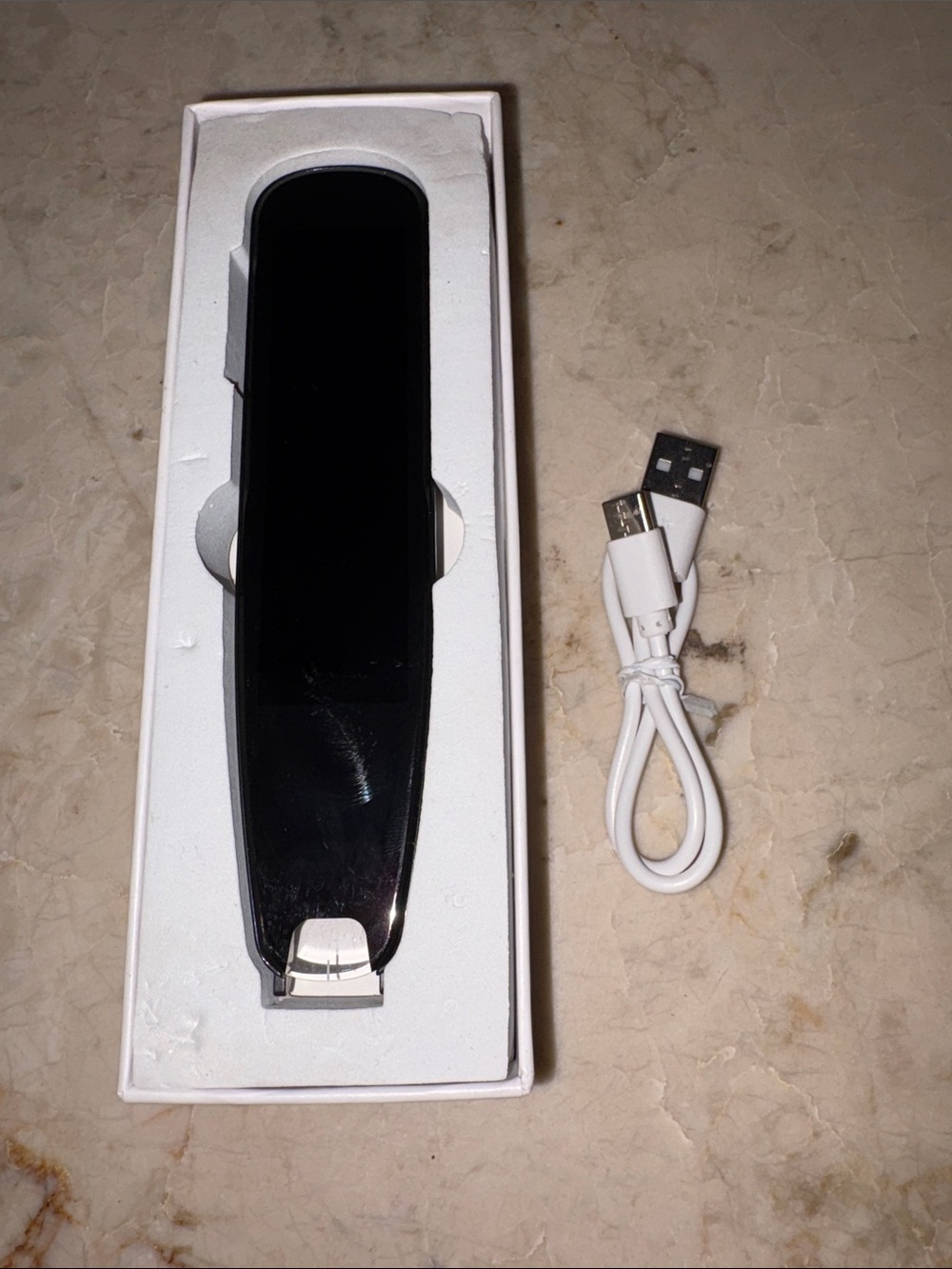 Sleek Black Handheld translator of different languages with USB Cableo